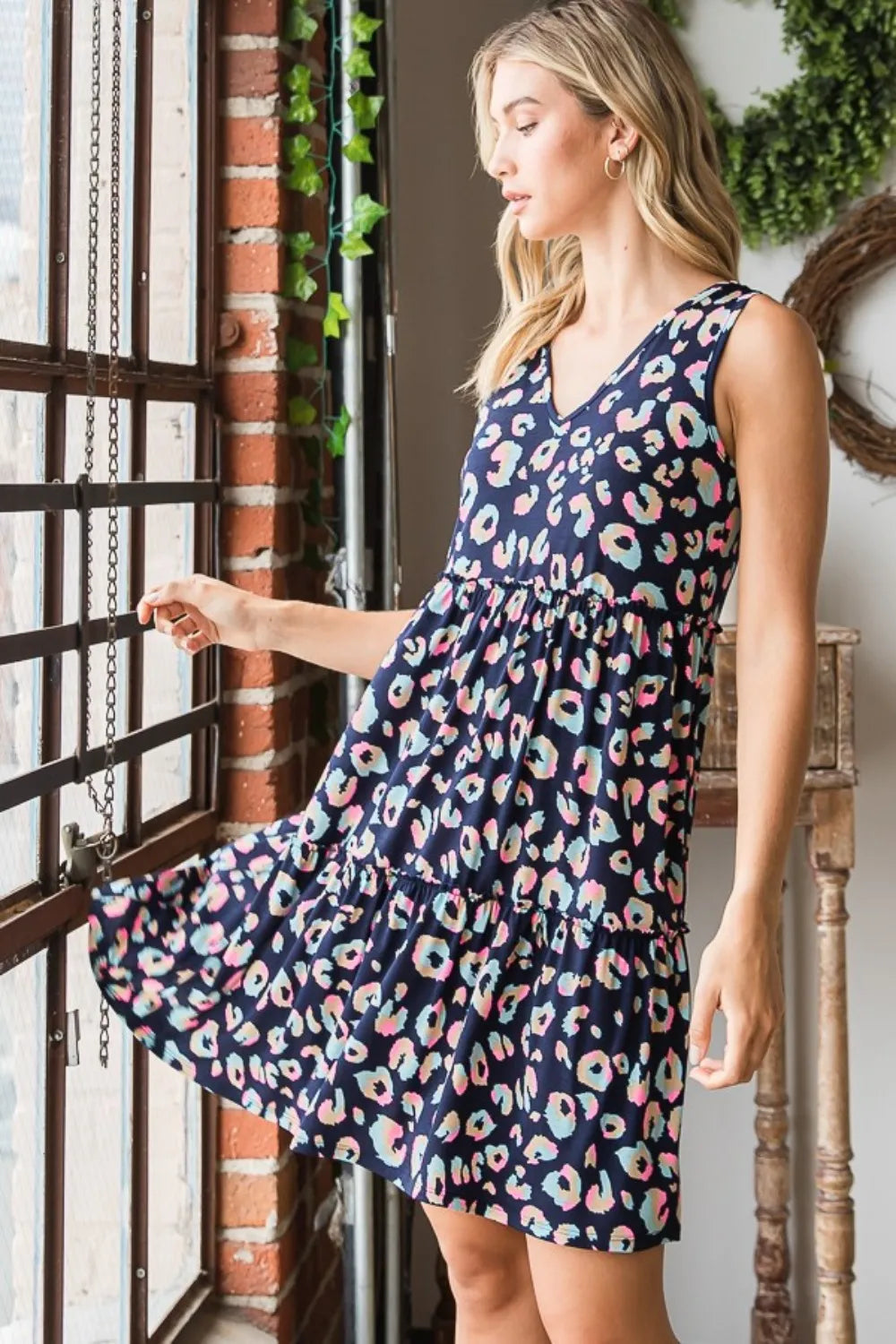 Navy multi-color Heimish full-size leopard V-neck ruffled tank dress displayed on a mannequin, showcasing its stylish design.