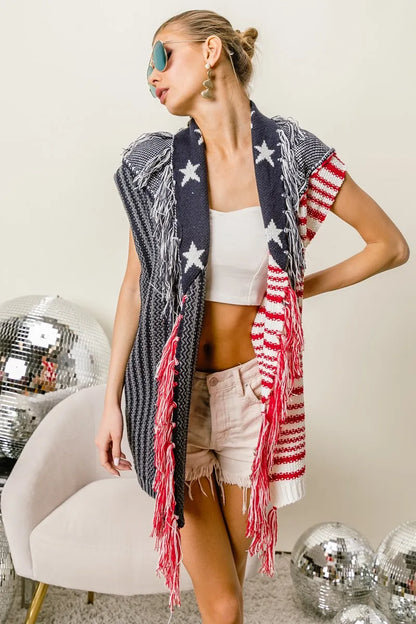 Navy and red BiBi American flag fringe-edged sweater vest by Trendsi, featuring patriotic star and stripe pattern on soft knit fabric.