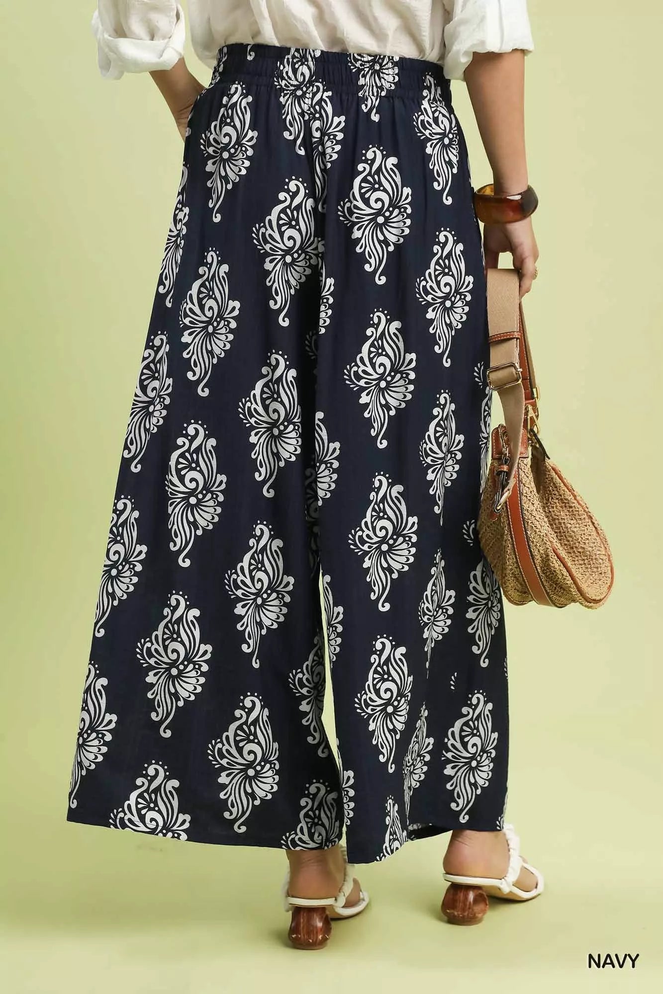 Navy Umgee abstract print wide-leg pants with relaxed fit and flowy fabric, styled with a casual top for a trendy look.