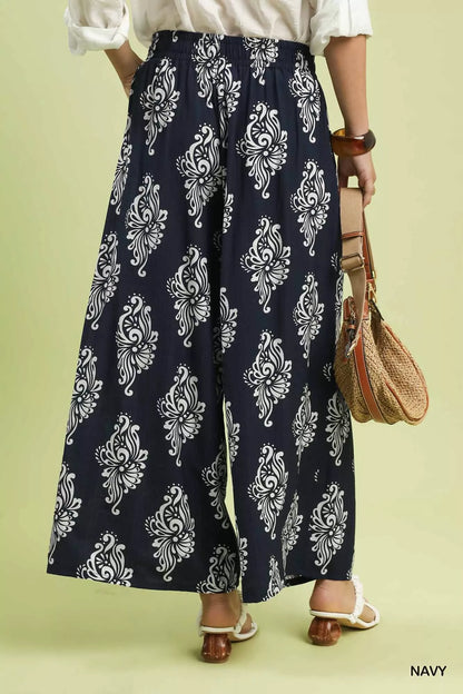 Navy Umgee abstract print wide-leg pants with relaxed fit and flowy fabric, styled with a casual top for a trendy look.