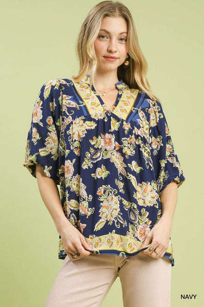 Navy Umgee Apricot Floral Boho Blouse with long sleeves and a relaxed fit, featuring a vibrant floral pattern.