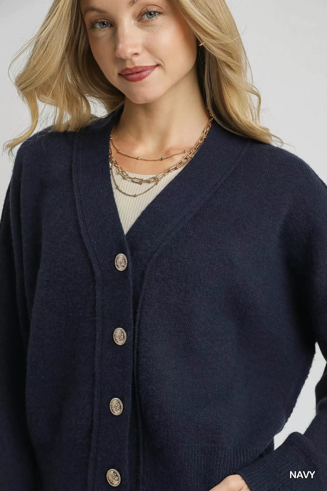 Navy Umgee button-front knit cardigan with long sleeves and ribbed cuffs, styled on a plain background.