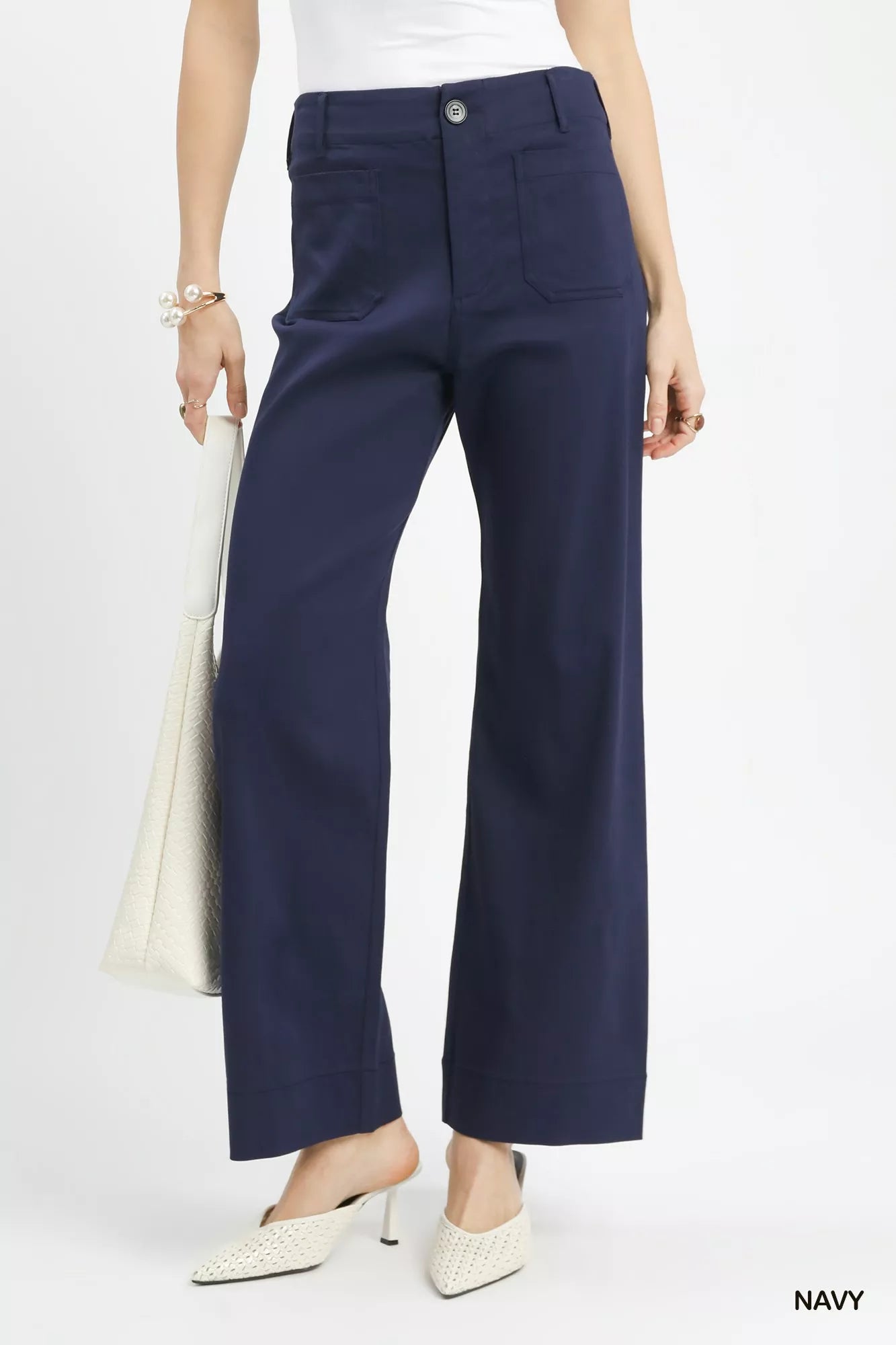 Navy Umgee button-stretched pants by Trendsi, featuring a relaxed fit with button details and comfortable stretch fabric.