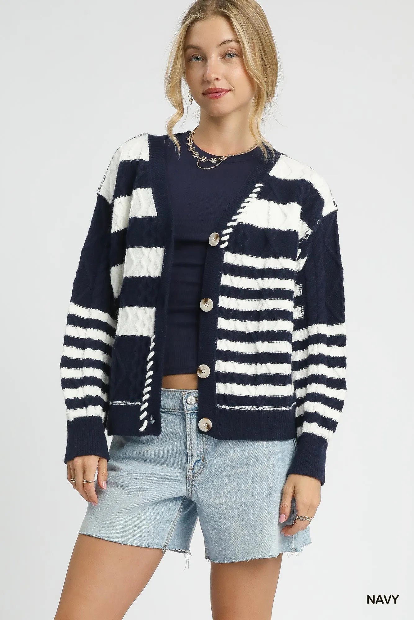 Navy Umgee cable-knit stripe button-up cardigan with front buttons, layered over a casual outfit for a cozy, stylish look.