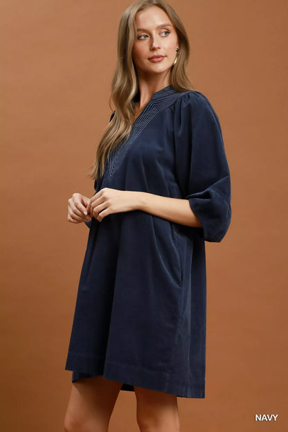 Navy Umgee corduroy V-neck puff sleeve shift dress with pockets, styled casually on a model.