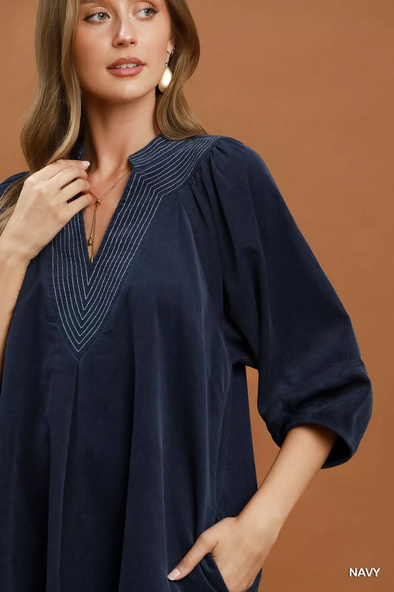 Navy Umgee corduroy V-neck puff sleeve shift dress with pockets, featuring a relaxed fit and stylish design.