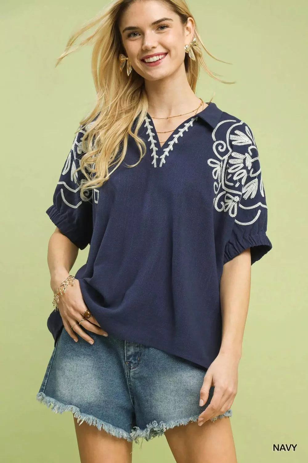 Navy floral embroidered sleeve blouse by Umgee featuring intricate embroidery on the sleeves and a relaxed fit.