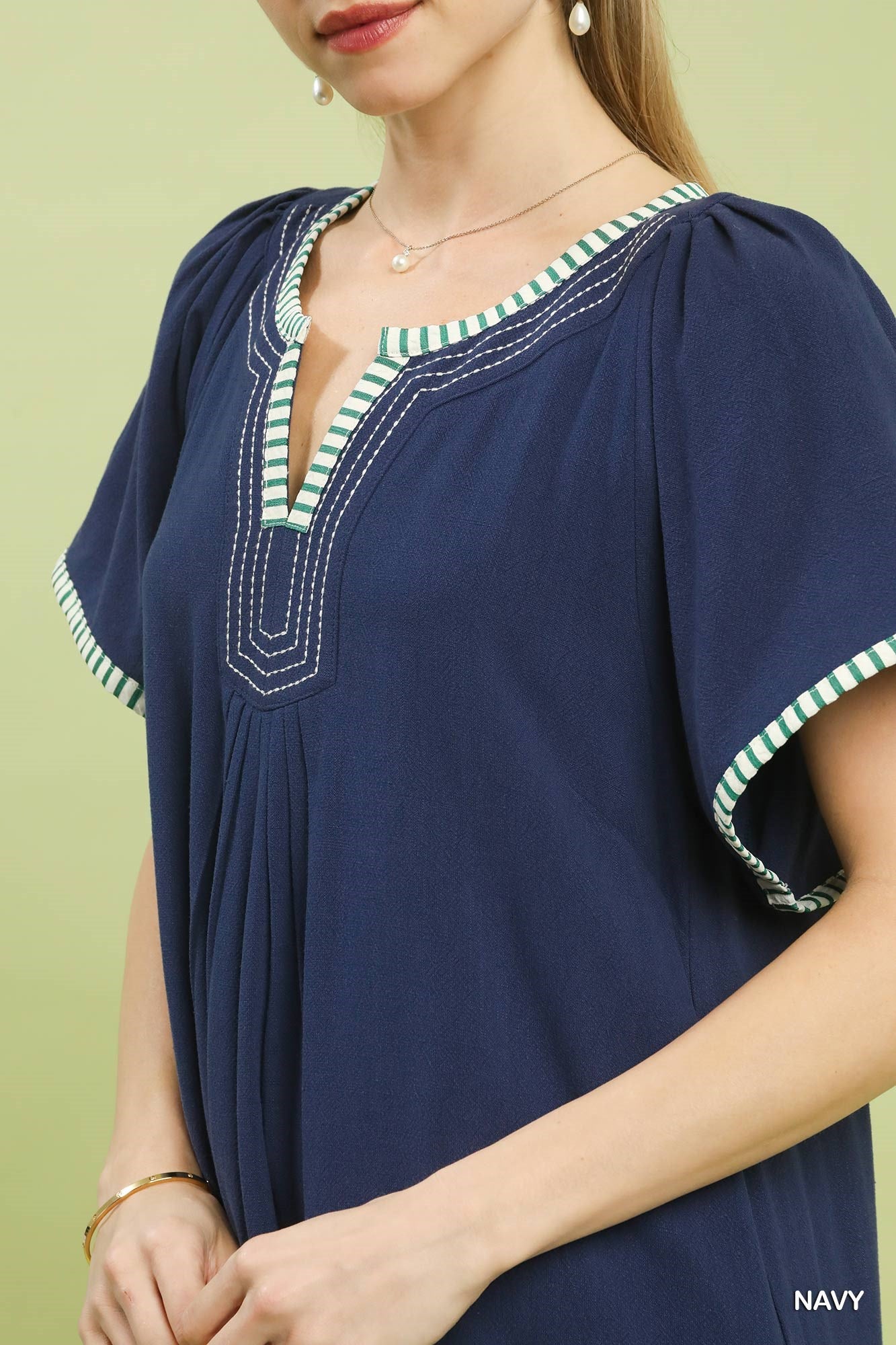Navy Umgee linen trim tunic dress with relaxed fit, short sleeves, and side pockets, styled for casual wear.