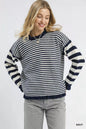 Navy Umgee stripe sweater with ruffle neck and long sleeves, styled casually on a model.