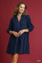 Navy Umgee tiered corduroy mini dress with balloon sleeves, featuring a stylish and cozy design perfect for casual wear.
