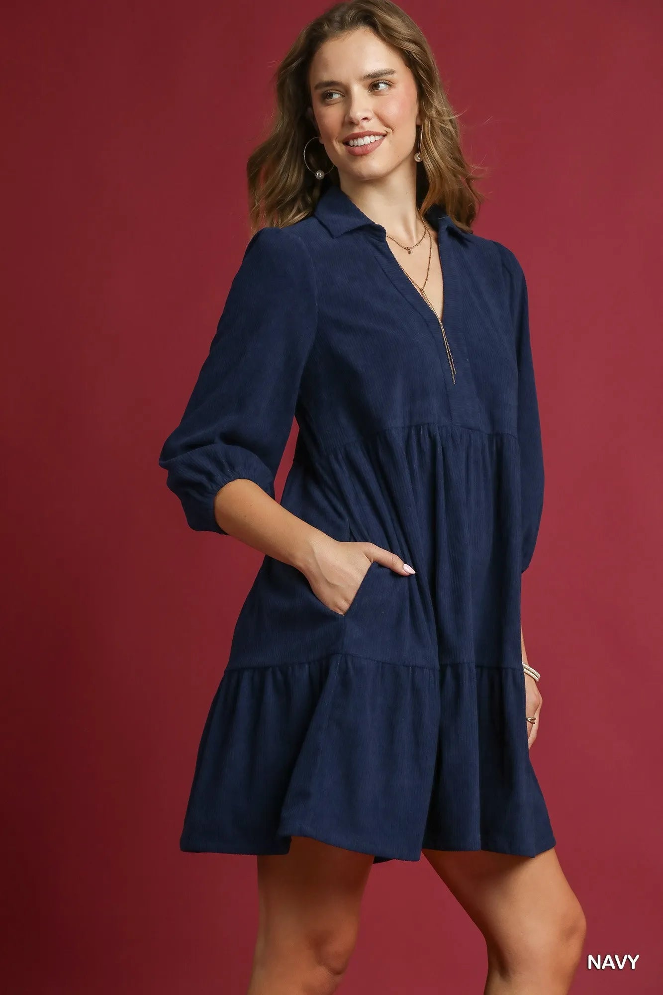 Navy Umgee tiered corduroy mini dress with balloon sleeves, stylish and comfortable for casual wear.