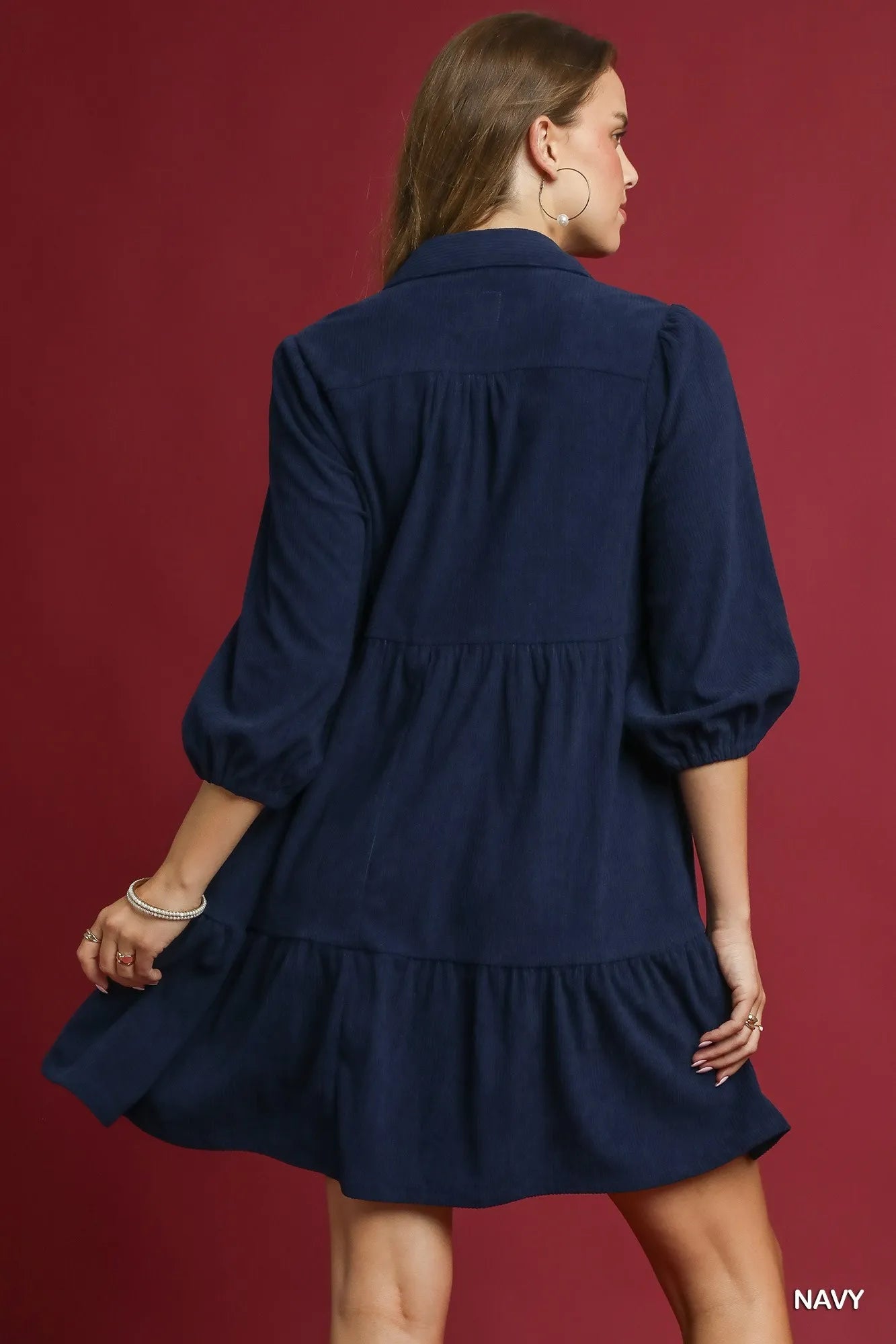 Navy Umgee tiered corduroy mini dress with balloon sleeves, featuring a stylish, relaxed fit and textured fabric.