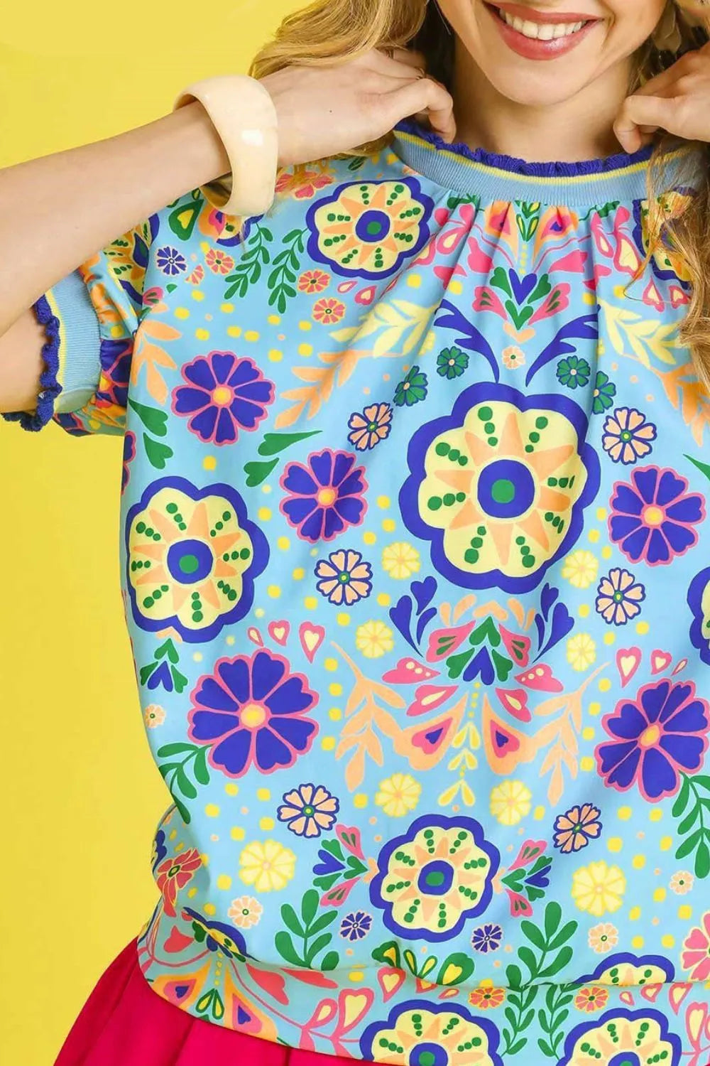 Navy Umgee retro floral puff sleeve top with ruffled cuffs, lightweight fabric, and vintage-inspired design.