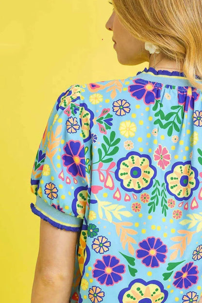 Navy Umgee Retro Floral Puff Sleeve Top with a fitted silhouette and vibrant floral pattern, styled for casual wear.