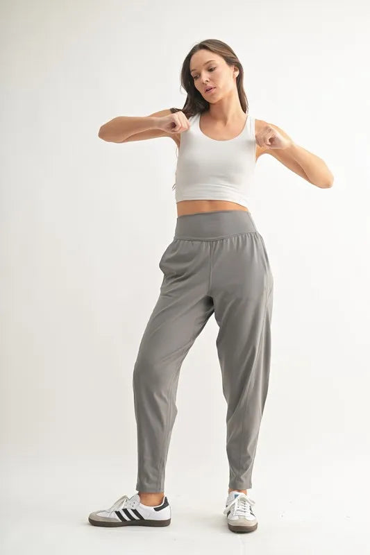 Trendsi MONO B Flowbarrel high waist active pants in pewter, shown on a model, featuring a sleek fit and comfortable stretch fabric.