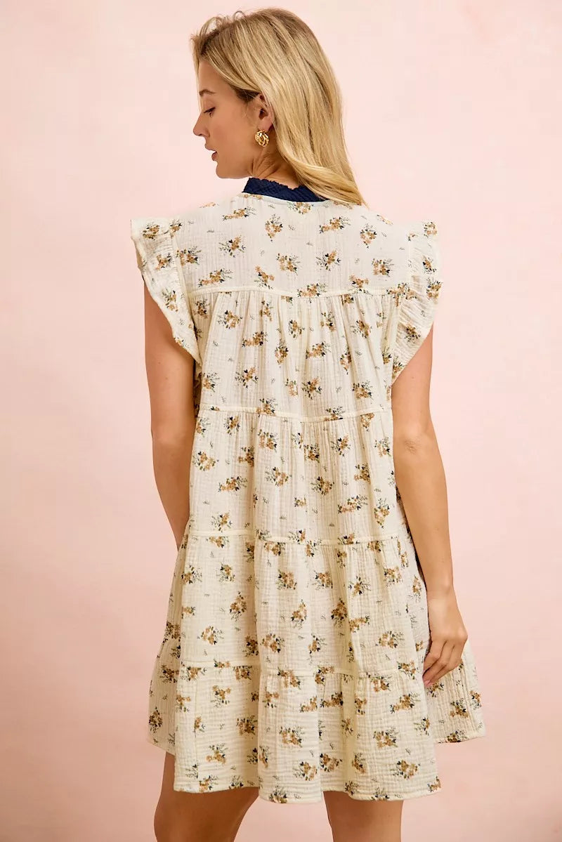 Oatmeal navy BiBi Floral multi-tiered dress with ruffles and front tie, by Trendsi, displayed on a model.