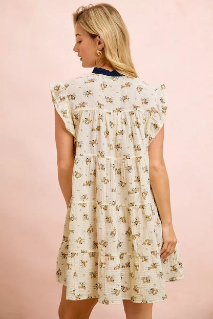 Oatmeal navy BiBi Floral multi-tiered dress with ruffles and front tie, by Trendsi, displayed on a model.