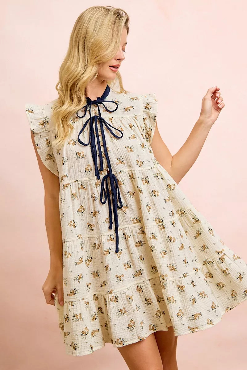 Oatmeal navy BiBi floral multi-tiered dress with ruffles and front tie, by Trendsi, featuring layered fabric and feminine design.