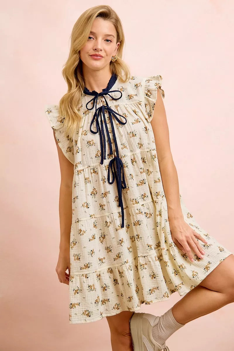 Oatmeal navy BiBi floral multi-tiered dress with ruffles and front tie, featuring a feminine, flowy design by Trendsi.