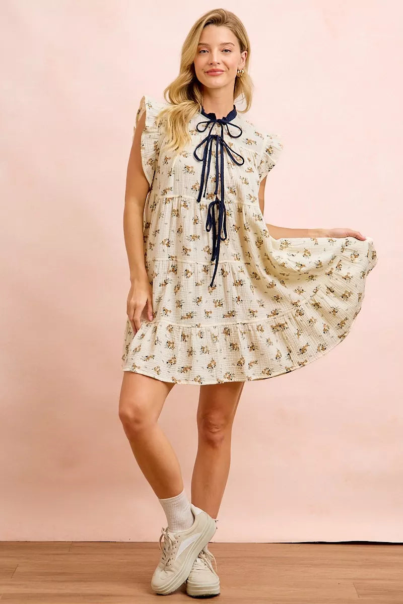 Trendsi BiBi floral multi-tiered dress in oatmeal navy with ruffles and front tie, showcasing a feminine, layered design.