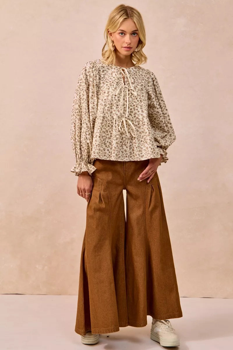 Oatmeal BiBi floral printed peplum blouse by Trendsi featuring shirring and a tied front detail.