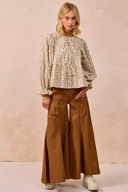 Oatmeal BiBi floral printed peplum blouse by Trendsi featuring shirring and a tied front detail.