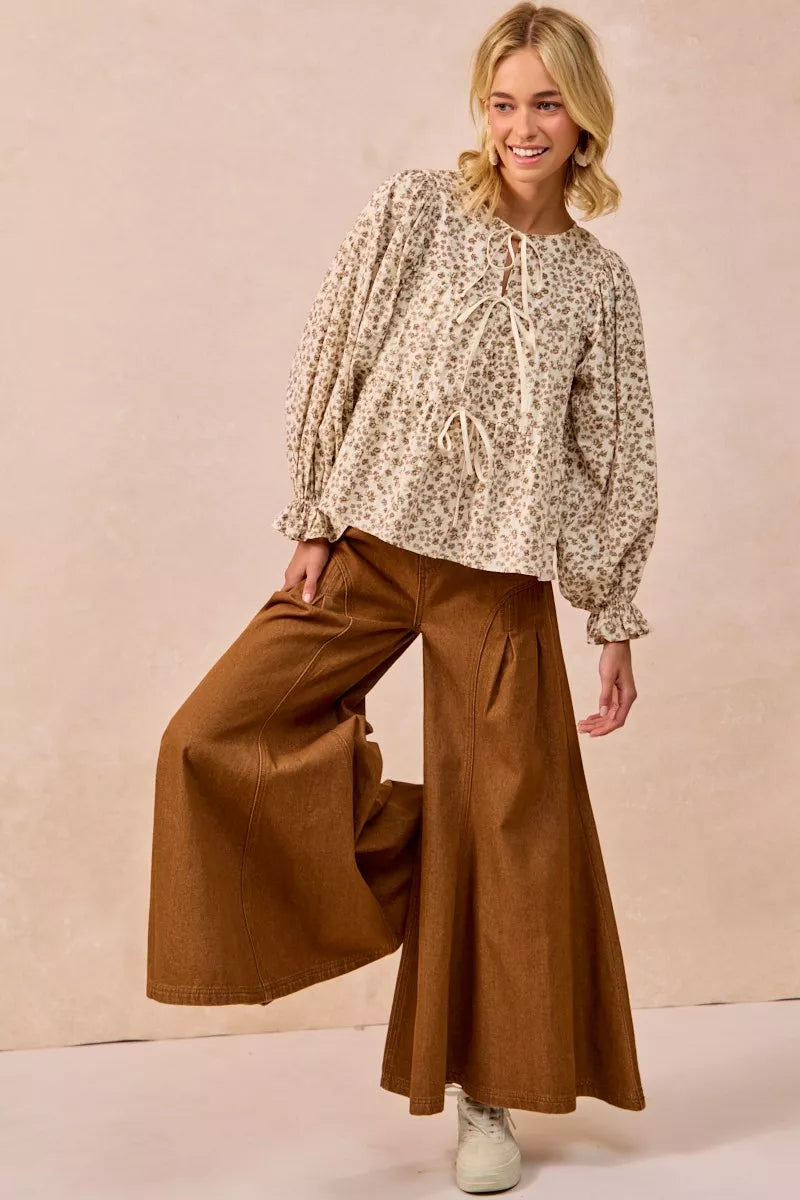 Oatmeal BiBi floral printed peplum blouse by Trendsi with shirring and tied front, featuring a feminine, flowy design.