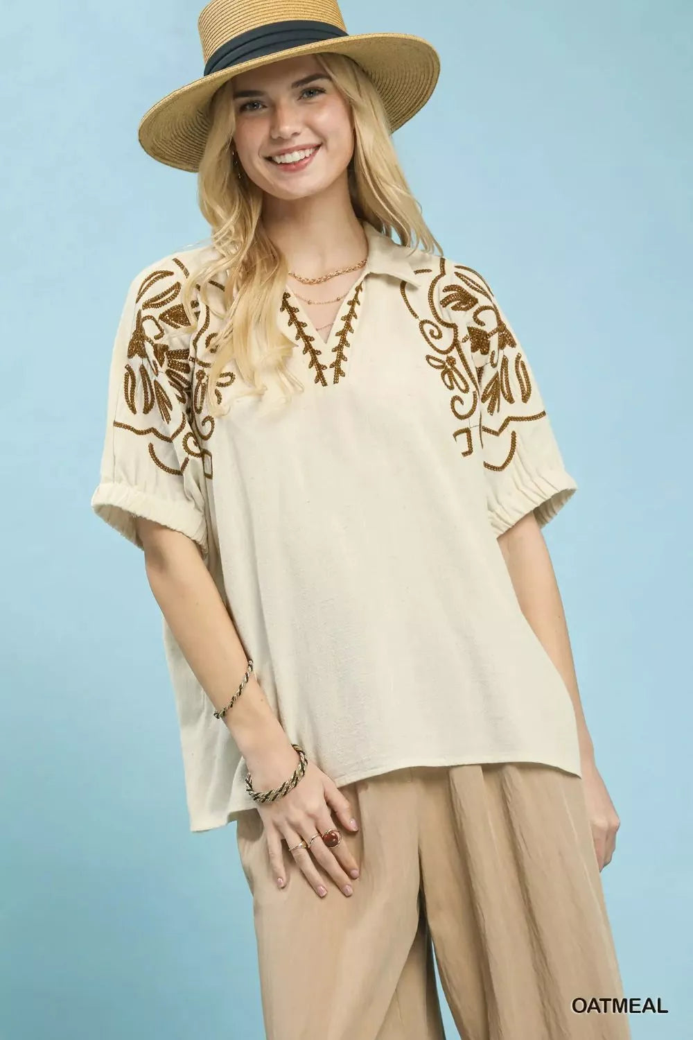 Oatmeal floral embroidered sleeve blouse by Umgee, featuring delicate embroidery and lightweight fabric, styled for casual wear.