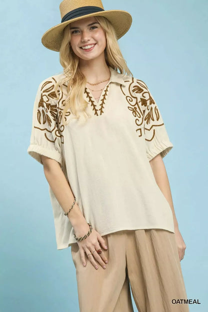 Oatmeal floral embroidered sleeve blouse by Umgee, featuring delicate embroidery and lightweight fabric, styled for casual wear.