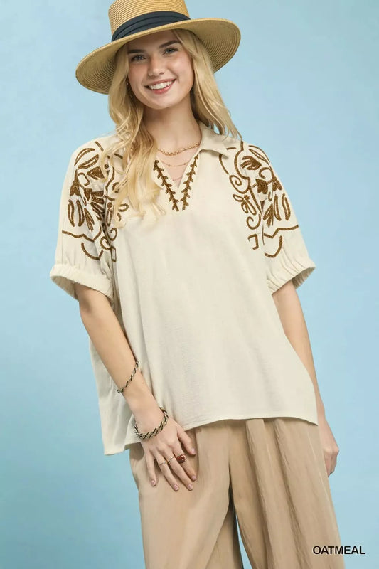 Oatmeal floral embroidered sleeve blouse by Umgee, featuring delicate embroidery and lightweight fabric, styled for casual wear.