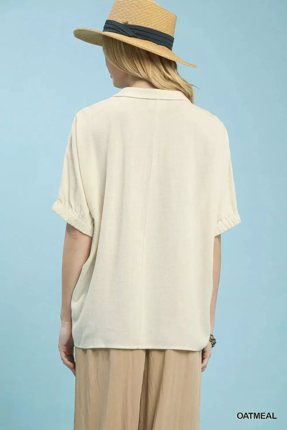 Oatmeal floral embroidered sleeve blouse by Umgee with delicate embroidery on sleeves, featuring a relaxed fit and feminine style.
