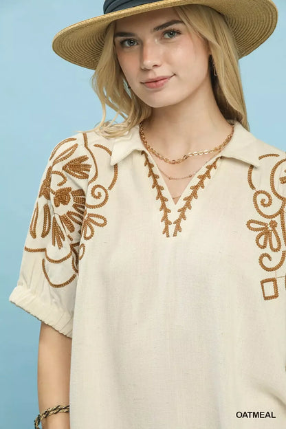 Oatmeal floral embroidered sleeve blouse by Umgee, featuring intricate floral embroidery and stylish long sleeves.