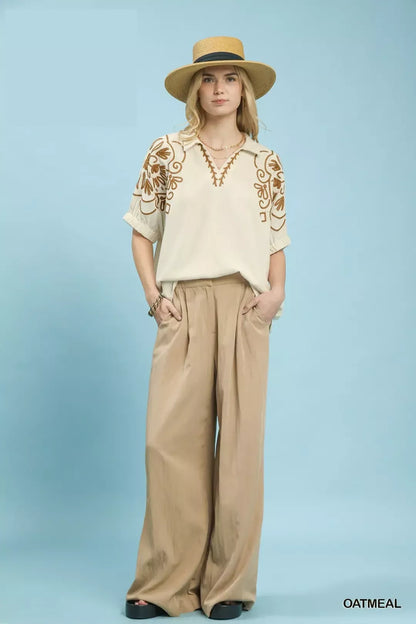 Oatmeal floral embroidered sleeve blouse by Umgee, featuring intricate floral embroidery on the sleeves and a relaxed fit.