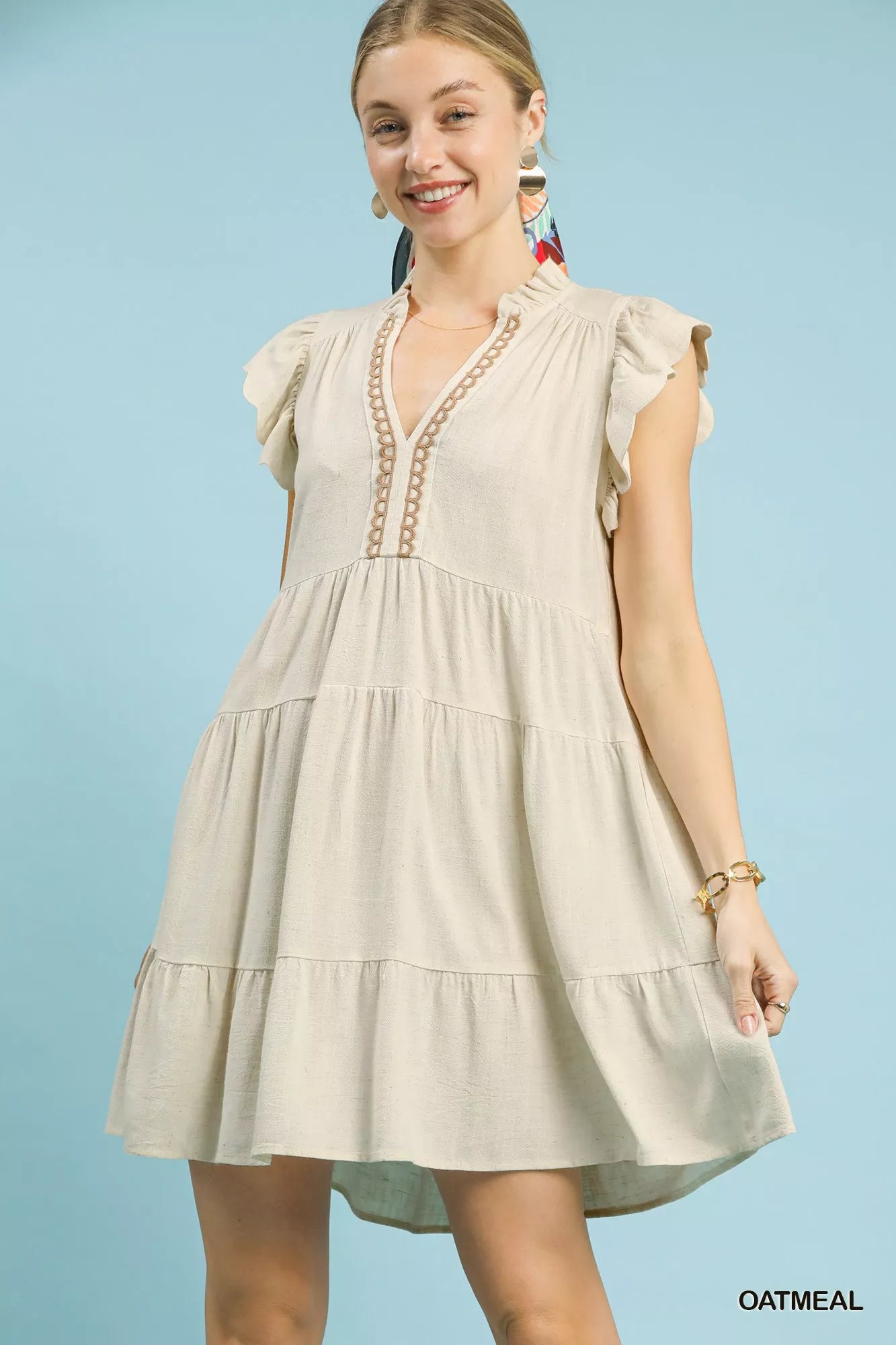 Oatmeal Umgee linen tiered baby doll dress with a relaxed fit, featuring ruffled tiers and sleeveless design.