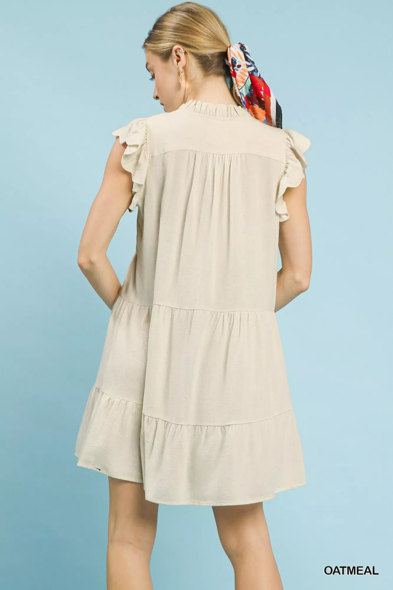Oatmeal linen tiered baby doll dress by Umgee featuring a flowy, layered design, perfect for casual or summer wear.