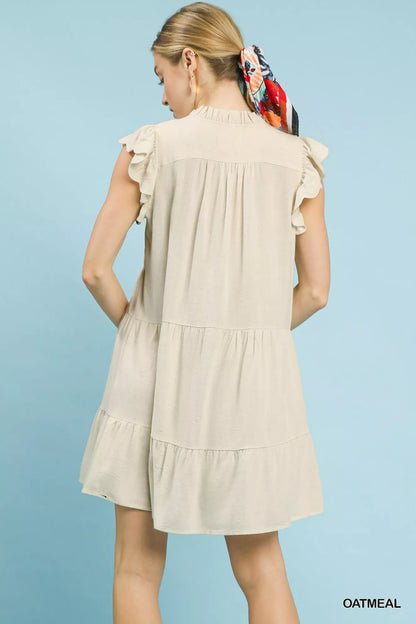 Oatmeal linen tiered baby doll dress by Umgee featuring a flowy, layered design, perfect for casual or summer wear.