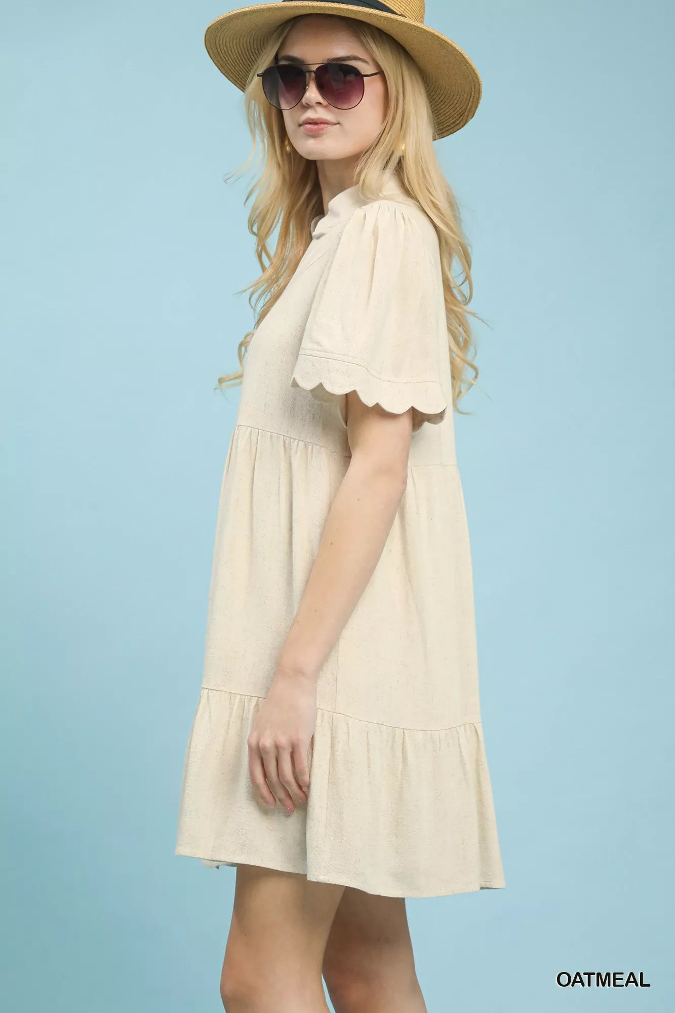 Oatmeal linen tiered babydoll dress with scalloped sleeves by Umgee, featuring a relaxed fit and feminine design.