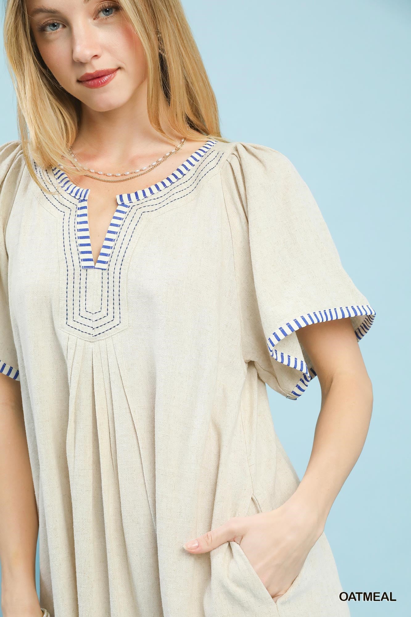 Oatmeal linen trim Umgee tunic dress by Trendsi, featuring a relaxed fit and casual style, shown on a model.