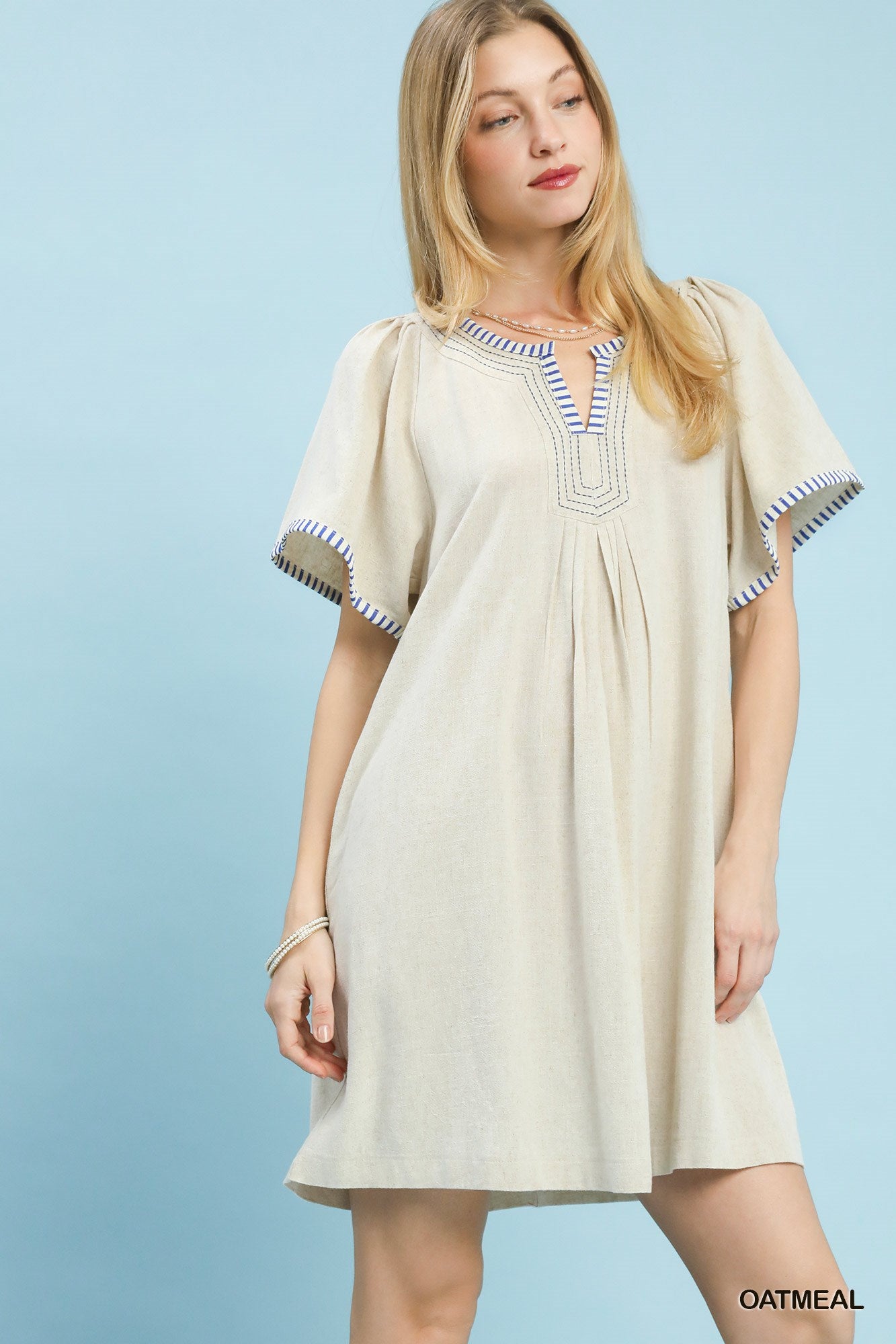 Oatmeal linen trim tunic dress by Umgee featuring a relaxed fit, short sleeves, and casual style, perfect for warm weather.