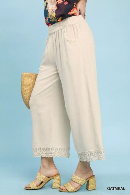 Oatmeal linen wide-leg cropped pants with lace trim by Umgee, featuring a relaxed fit and stylish detailing.