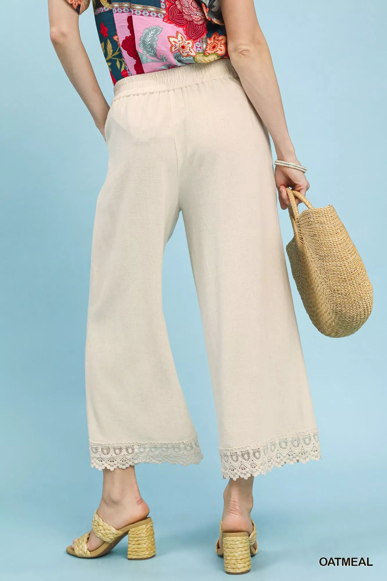 Oatmeal linen wide-leg cropped pants with lace trim by Umgee, styled with a relaxed fit and elegant lace detailing.