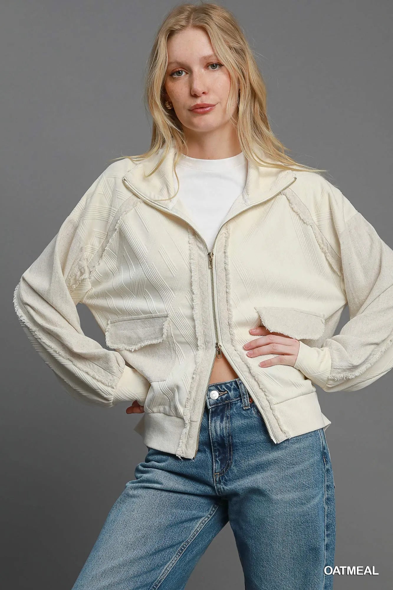 Oatmeal Umgee two-way jacquard zip-up jacket with textured pattern and front zipper, stylish and versatile for casual wear.