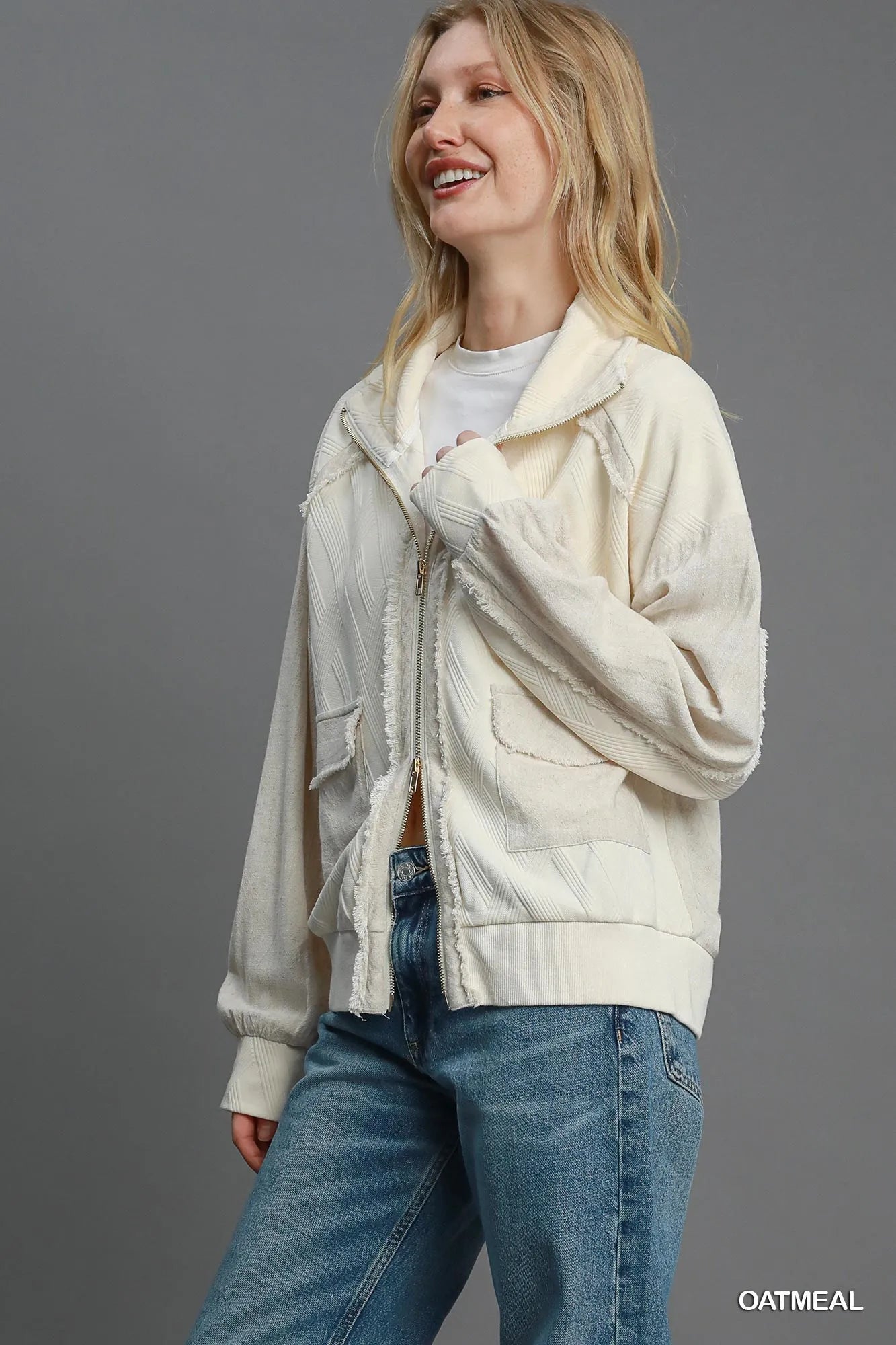 Oatmeal Umgee Two-Way Jacquard Zip-Up Jacket featuring a textured pattern and front zipper, stylish and versatile outerwear.