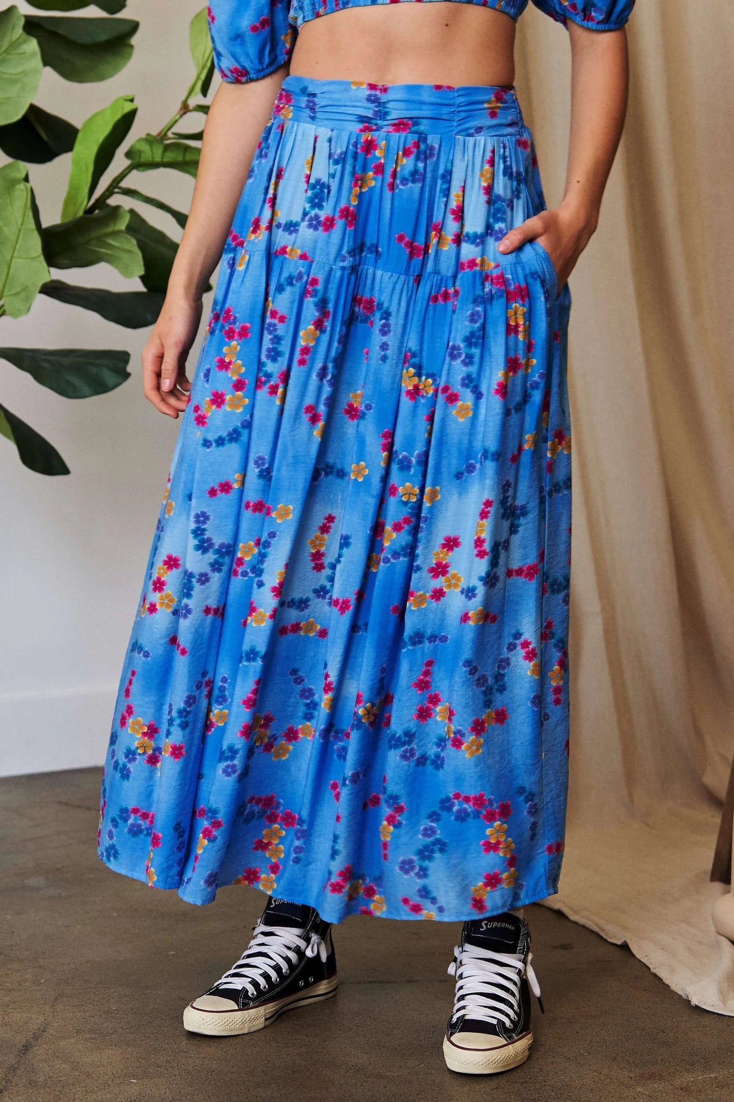 Ocean blue Davi & Dani printed maxi skirt with smocking waistband and ruffled hem, perfect for casual or summer wear.