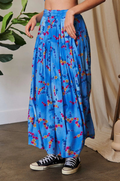 Ocean blue Davi & Dani printed maxi skirt with smocking waistband and ruffled hem, perfect for a stylish, flowy look.