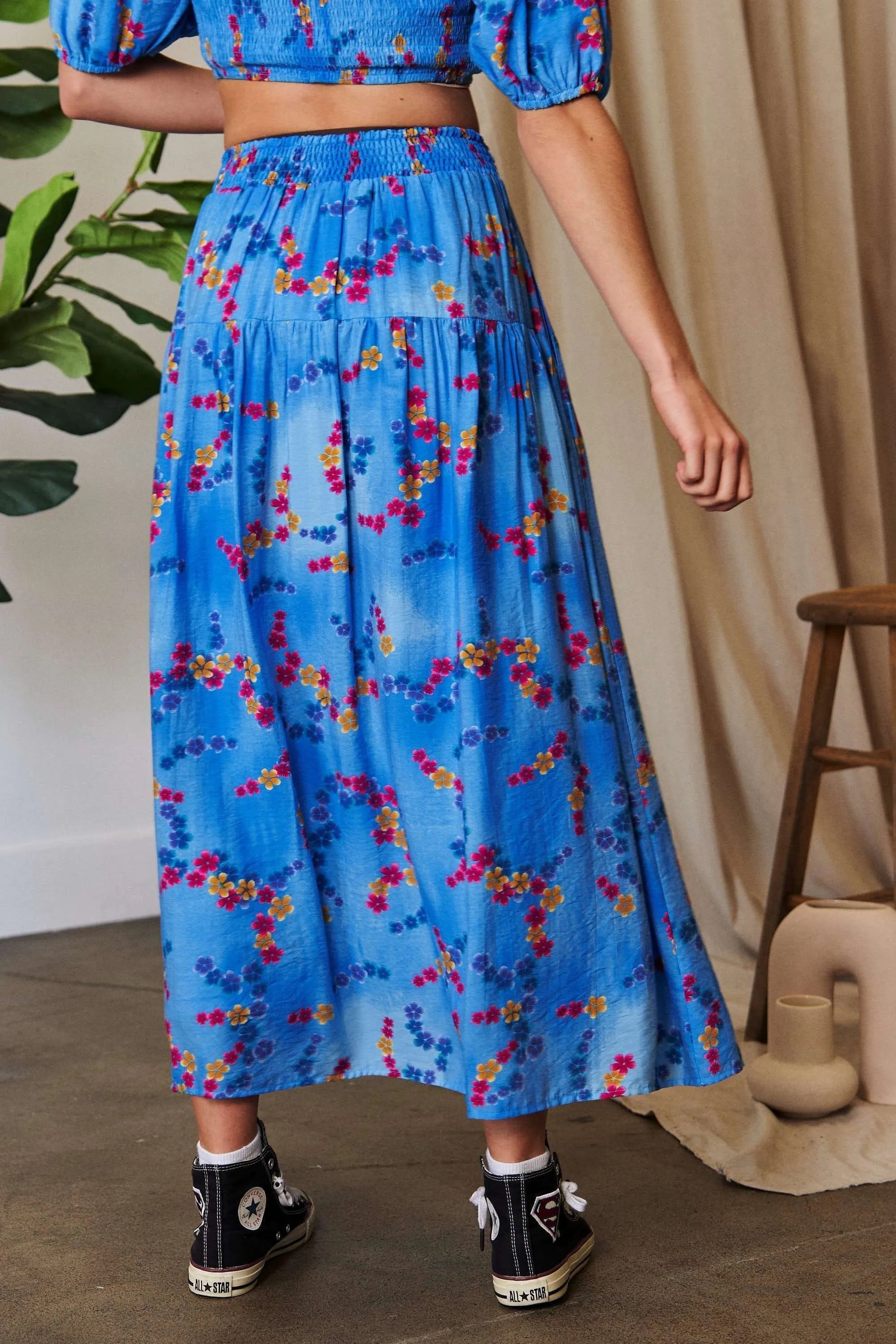 Ocean blue Davi & Dani printed maxi skirt with smocking waistband and ruffled hem, perfect for casual or dressy summer looks.