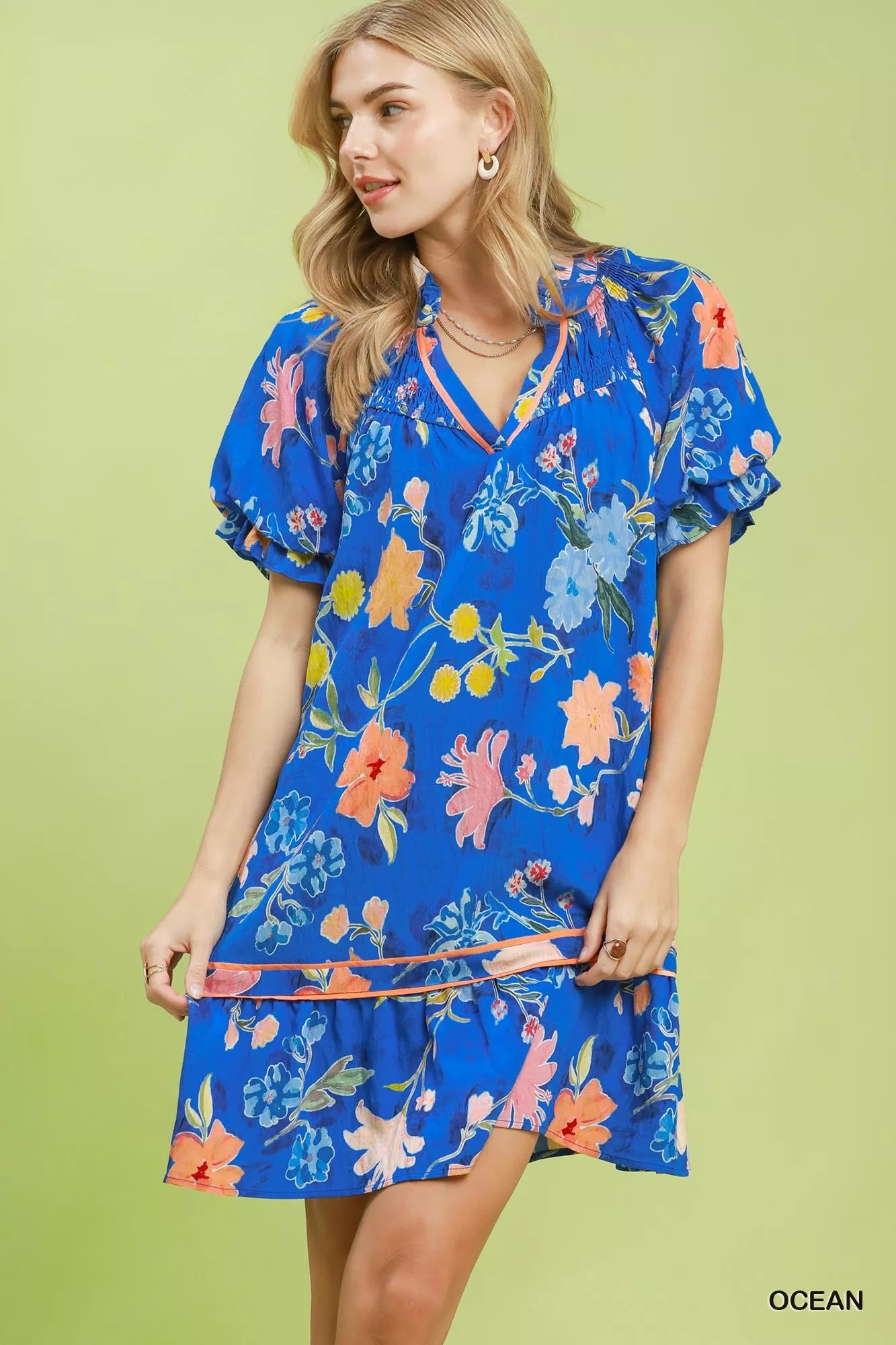 Umgee floral ruffle hem mini dress from Trendsi, featuring a vibrant floral pattern and feminine ruffle details.