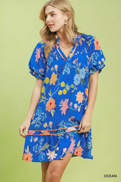 Umgee floral ruffle hem mini dress from Trendsi, featuring a vibrant floral pattern and feminine ruffle details.