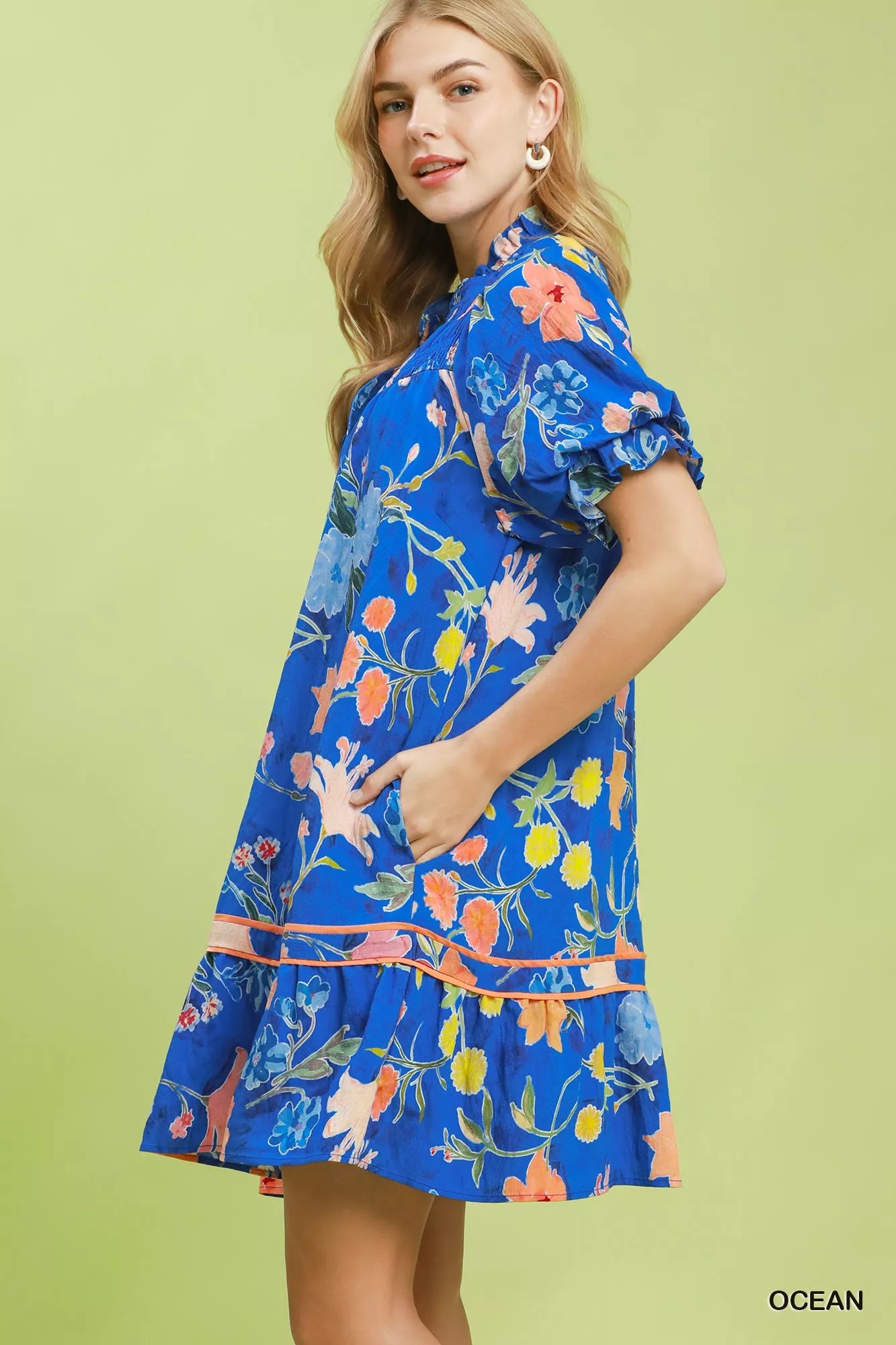 Umgee floral ruffle hem mini dress by Trendsi featuring a vibrant floral pattern and feminine ruffle details.