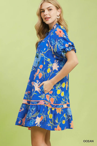 Umgee floral ruffle hem mini dress by Trendsi featuring a vibrant floral pattern and feminine ruffle details.